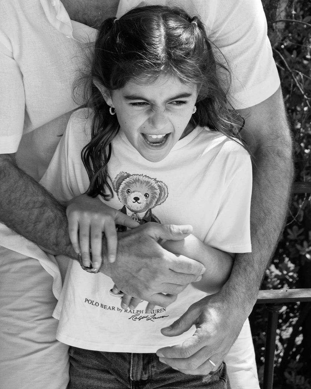 father's hands hugging daughter