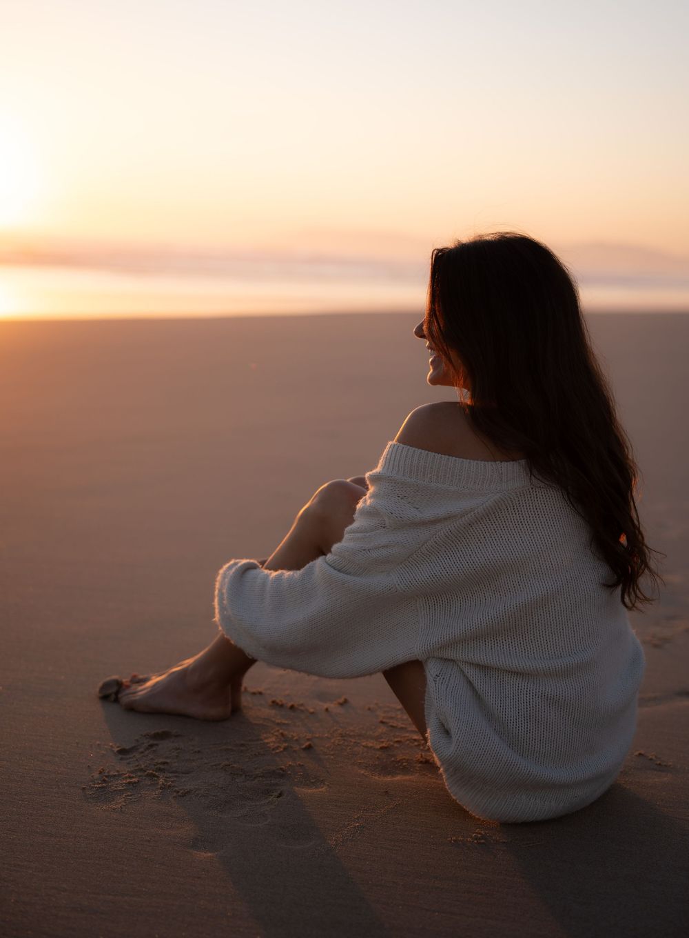 woman sitting on the beach