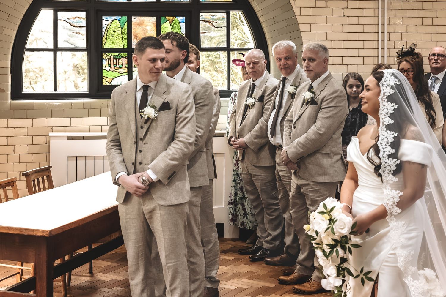 Documentary wedding image of the moment the groom sees his bride at wedding ceremony.