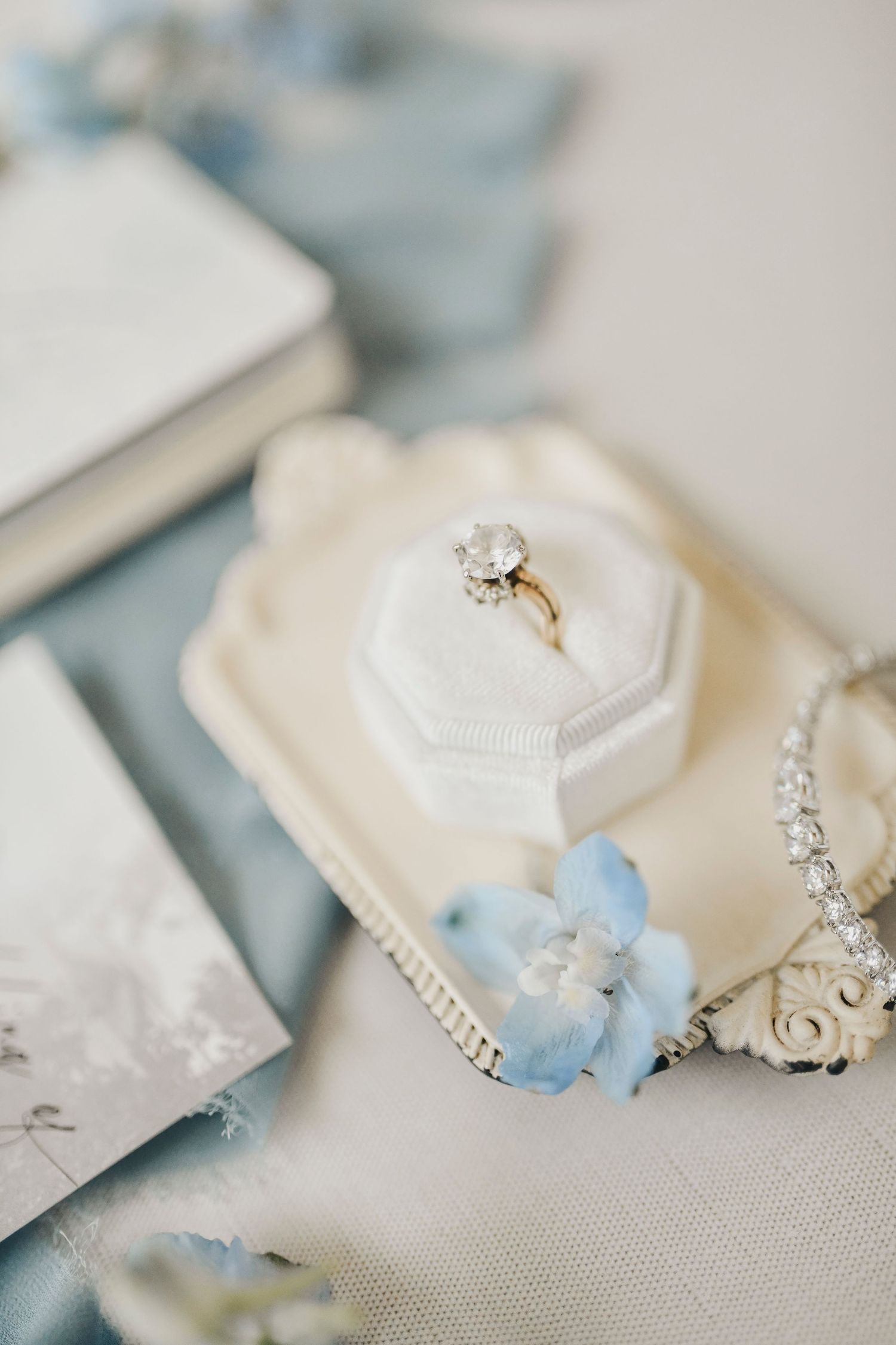 Gardenia venue bridal flat lay with dusty blue palette and elegant textures