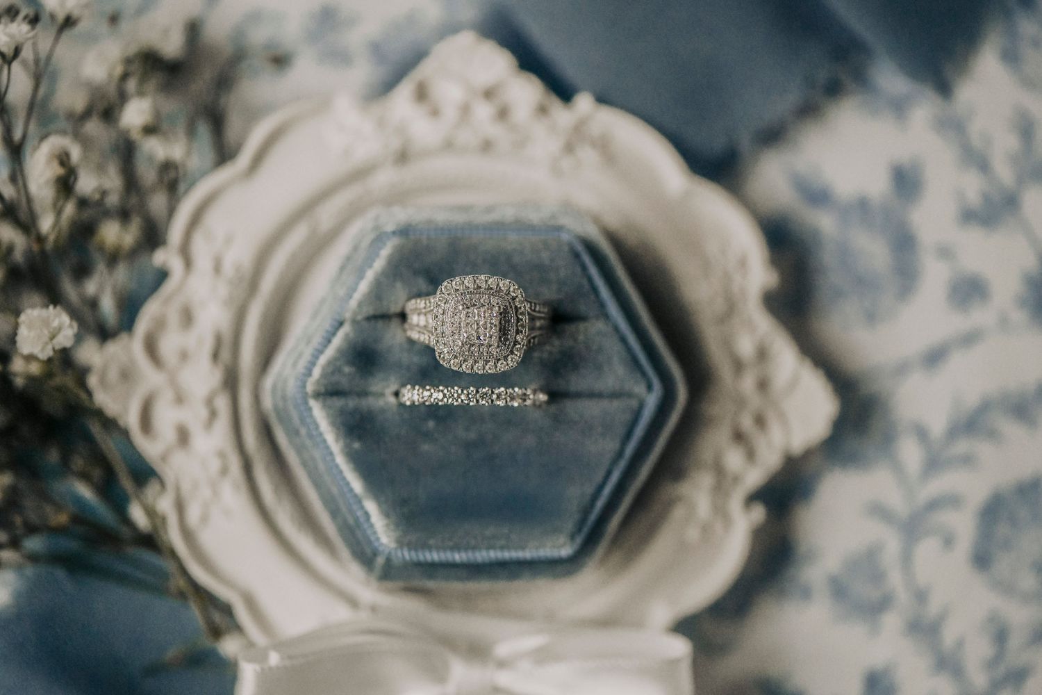 editorial close-up of engagement ring and wedding bands in natural light