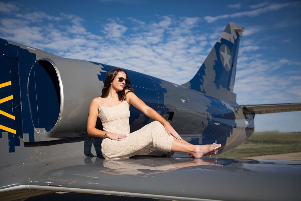 Modern High school senior portrait with jet plane in Howell Michigan; senior aviation photos by South Lyon, MI photographer