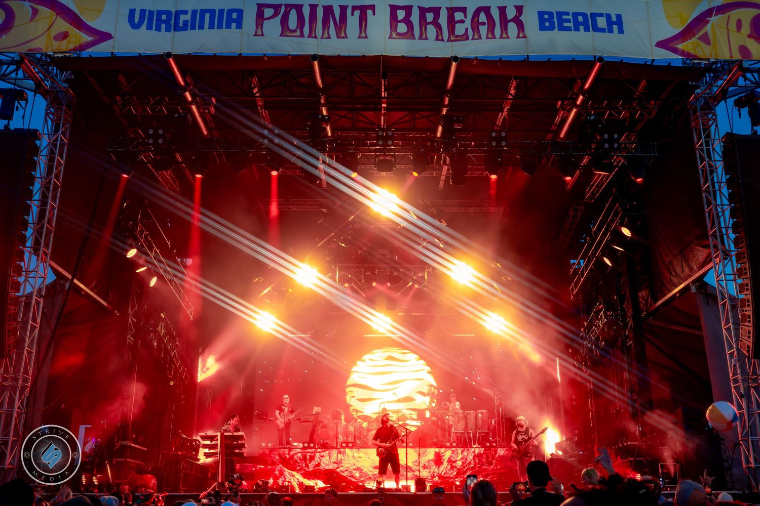 Virginia Point Break Beach festival stage with dramatic red lighting and laser beams.