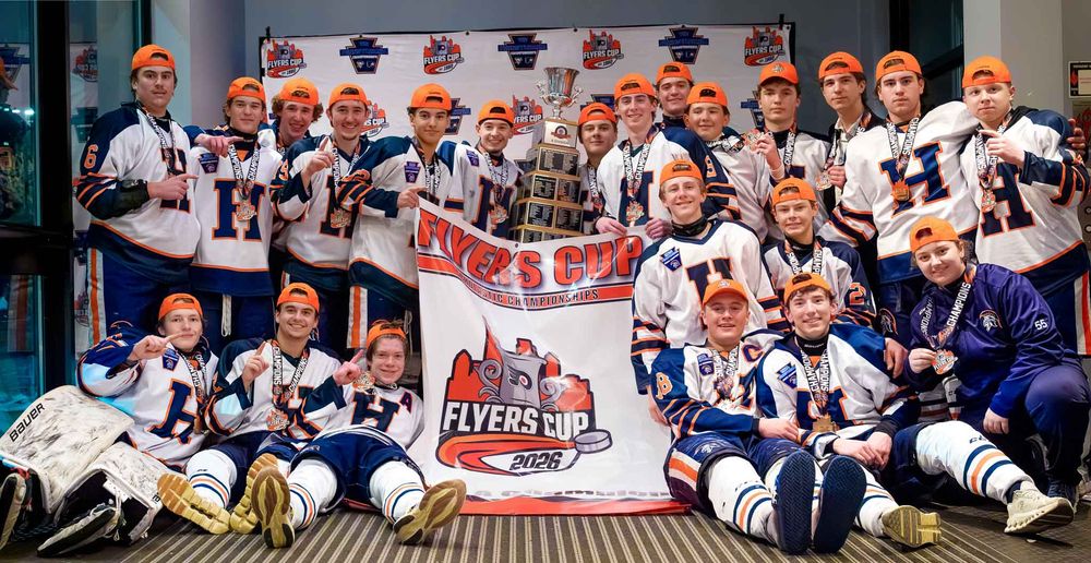 Hershey Trojans pose holding the Flyers Cup championship banner by Deanna Fox, SportsFox Photography based in Hershey PA.