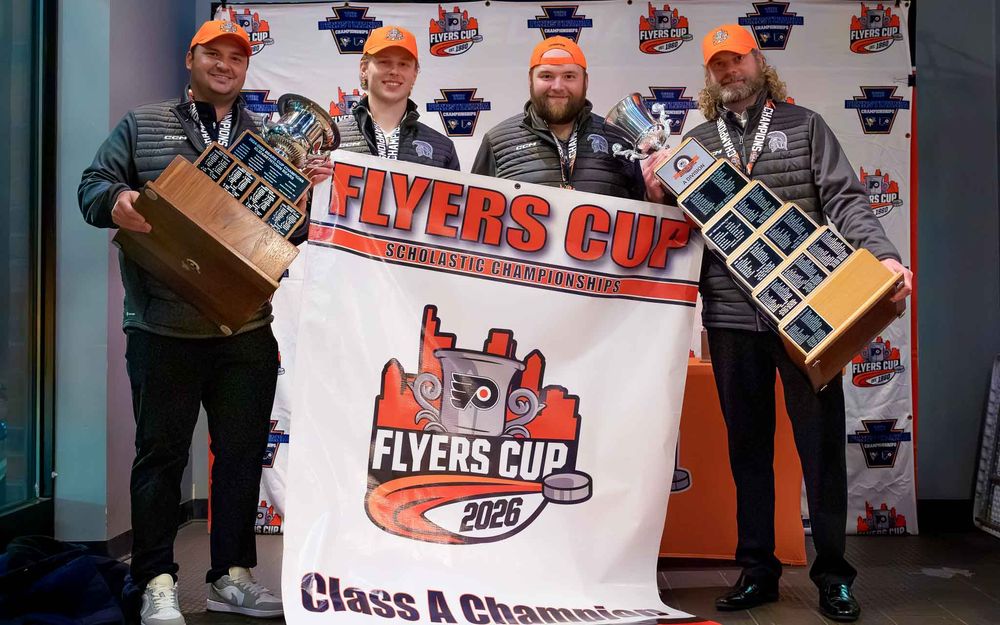 Hershey coaches hold the Flyers Cup trophy at the championship backdrop by Deanna Fox, SportsFox Photography based in Hershey PA.