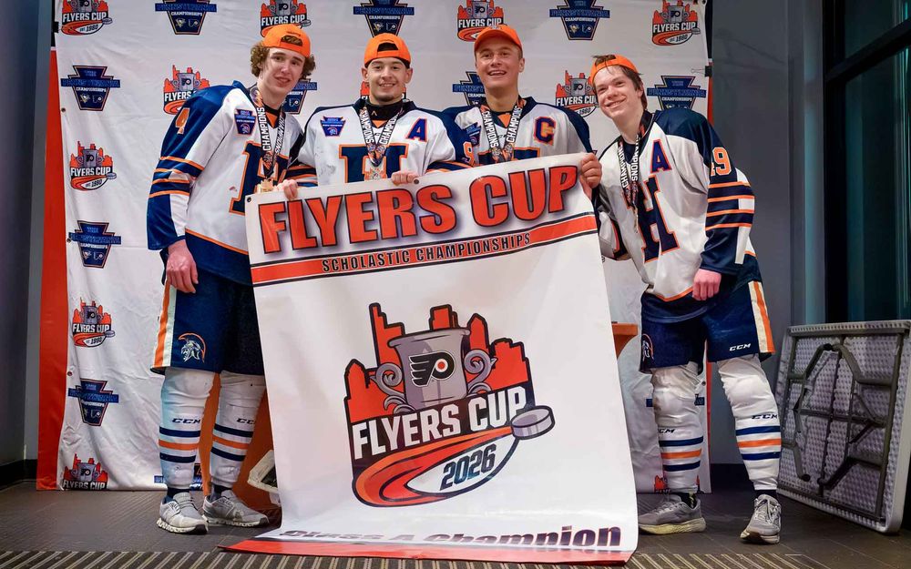 Hershey Trojan Captains with the Flyers Cup backdrop after the championship win by Deanna Fox, SportsFox Photography based in Hershey PA.