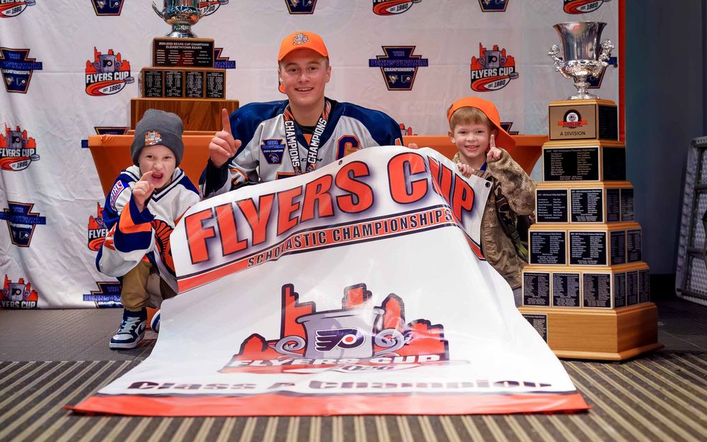 Blake Umberger poses with the Flyers Cup trophy at the championship backdrop by Deanna Fox, SportsFox Photography based in Hershey PA.
