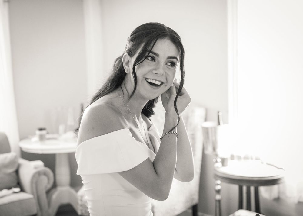 A sequence of candid black and white photos showing someone in a bridal gown laughing and smiling.