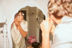 An elegant vintage-style scene showing a mirror reflection and morning beauty preparations.