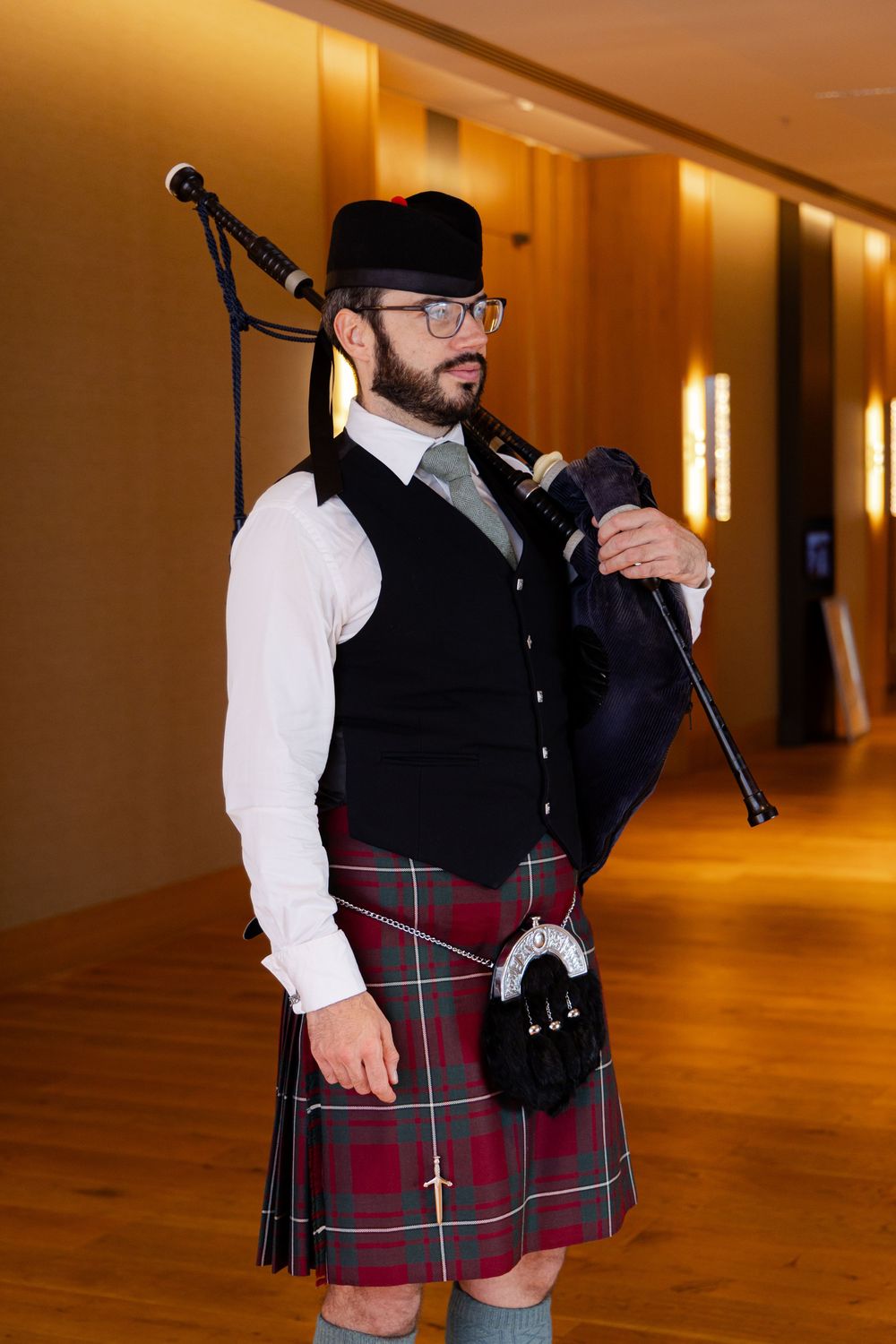 A man in a traditional Scottish kilt and vest. Perth Bagpipes