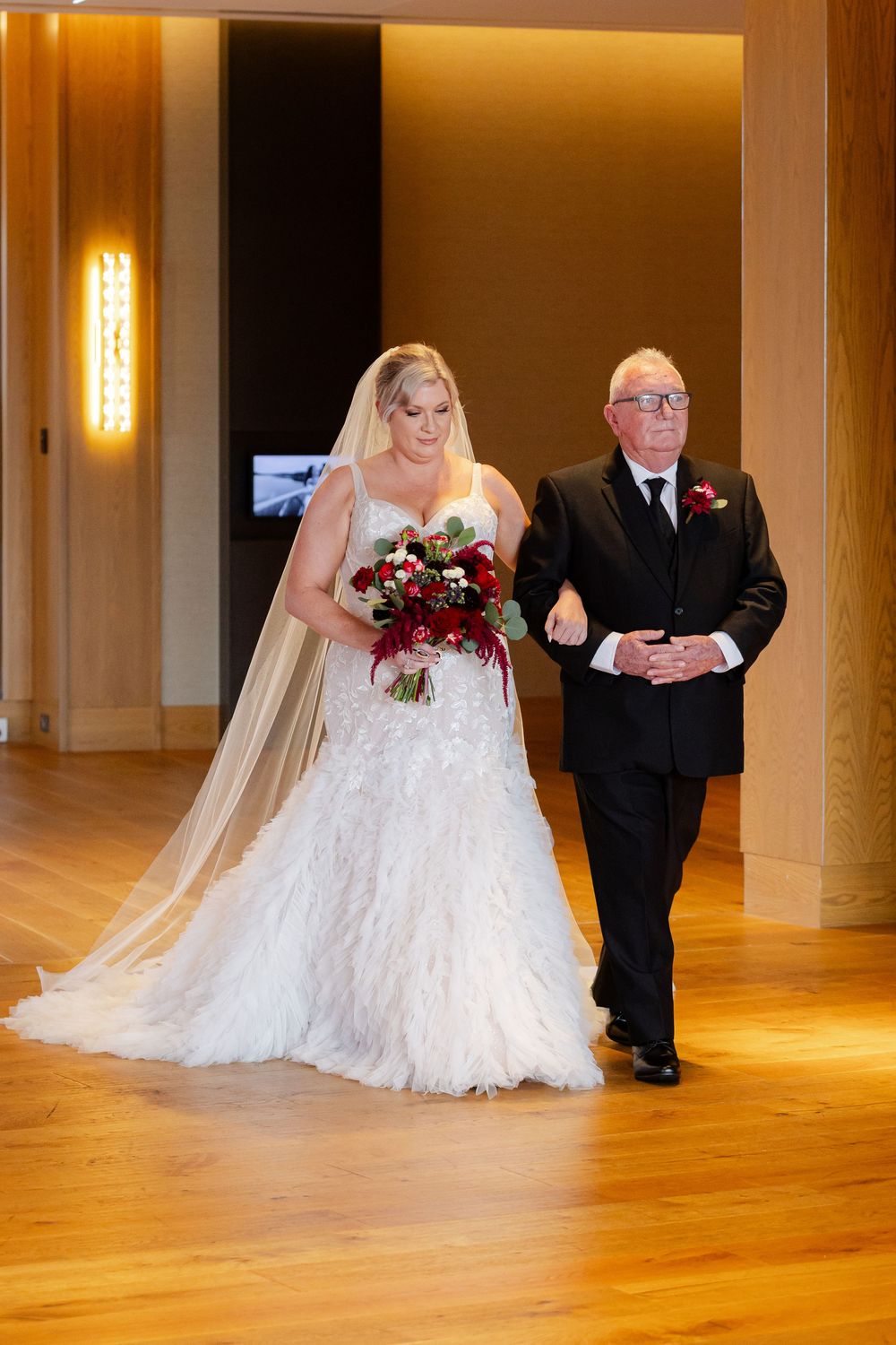 Bride entering wedding ceremony and carrying bouquet