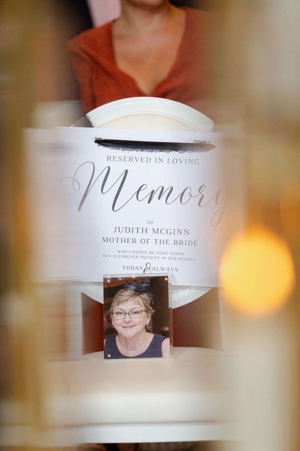 Memorial display at wedding reception with name cards honoring loved ones in memory.