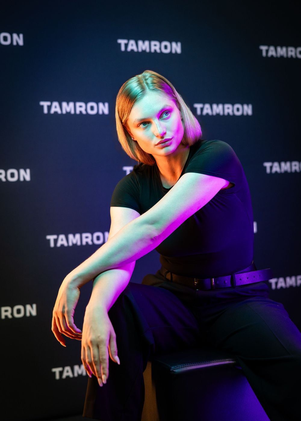 Dramatic fashion portrait with colorful lighting effects at Tamron event.