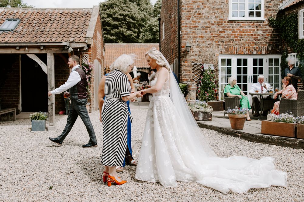 Festive wedding celebration captured in a sequence showing reception guests dancing and mingling at a rustic brick venue.