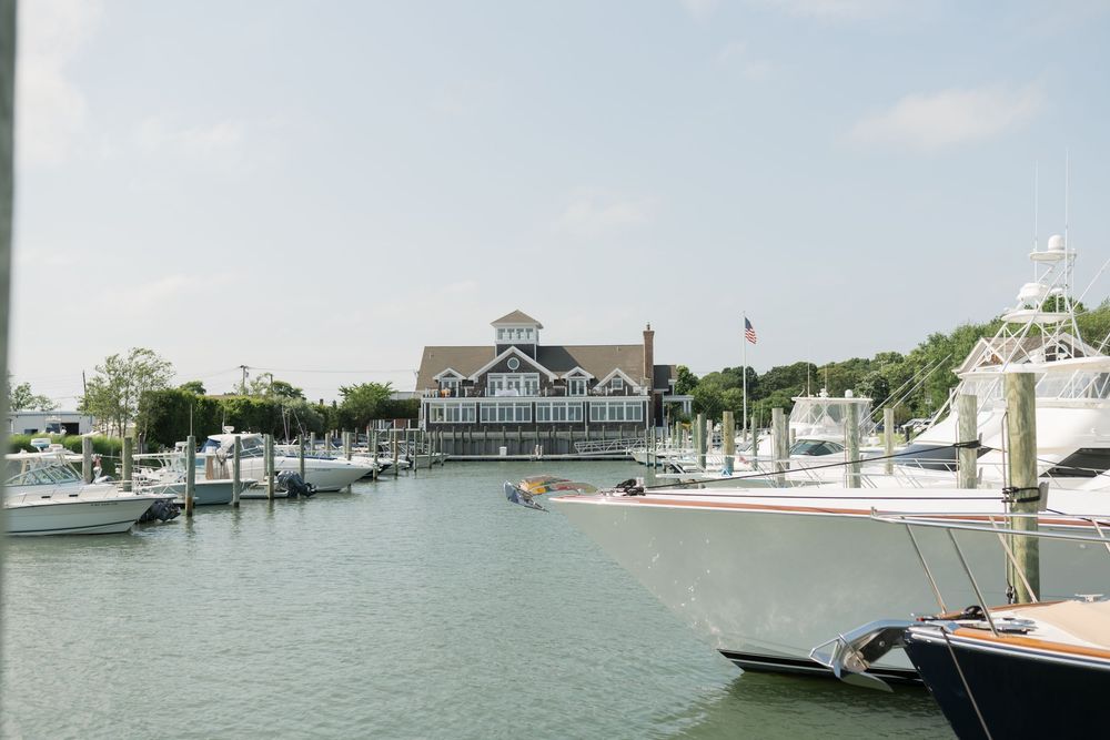 Marina view with boats docked at a waterfront yacht club.
