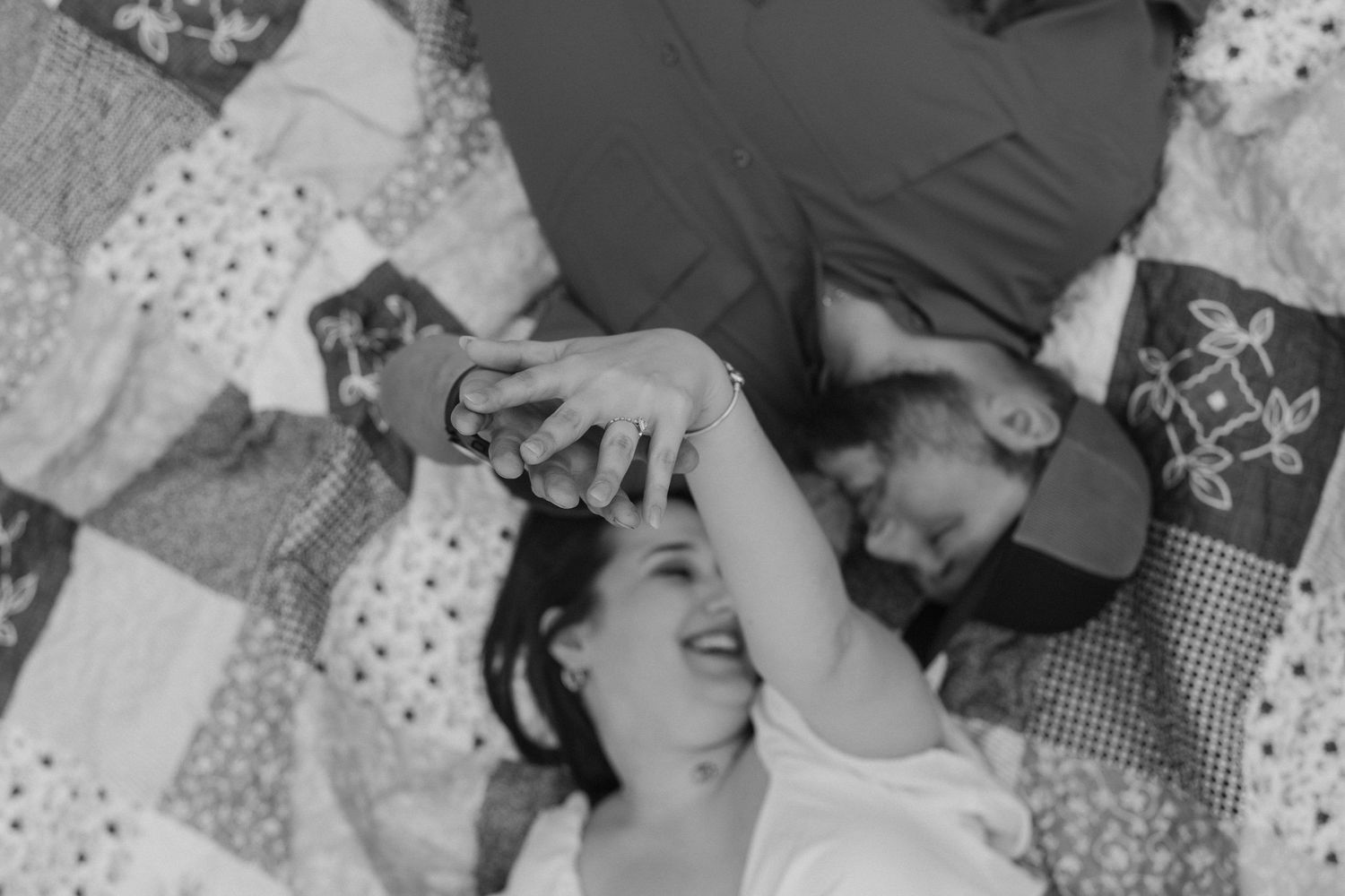 Black and white romantic portrait of a loving couple embracing outdoors in a park setting.