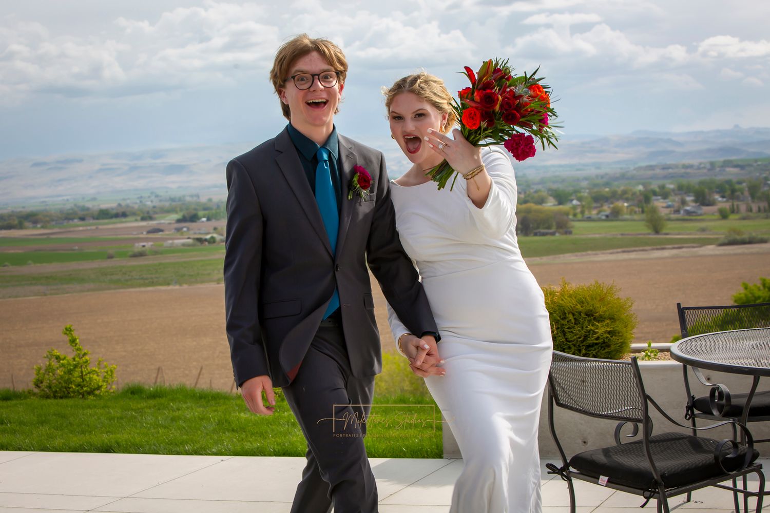 bride and groom walking holding hands showing off wedding rings making funny faces