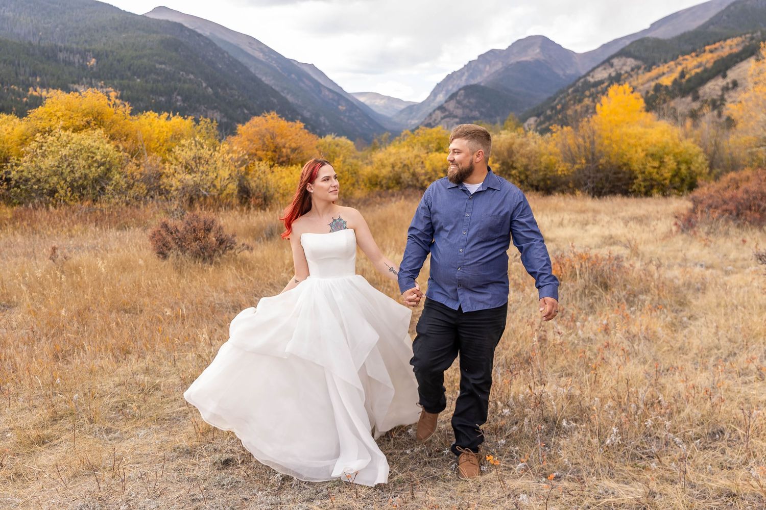 bride and groom in open meadow at Moraine Park, mountain views and elk nearby, fall elopement in Rocky Mountain National Park