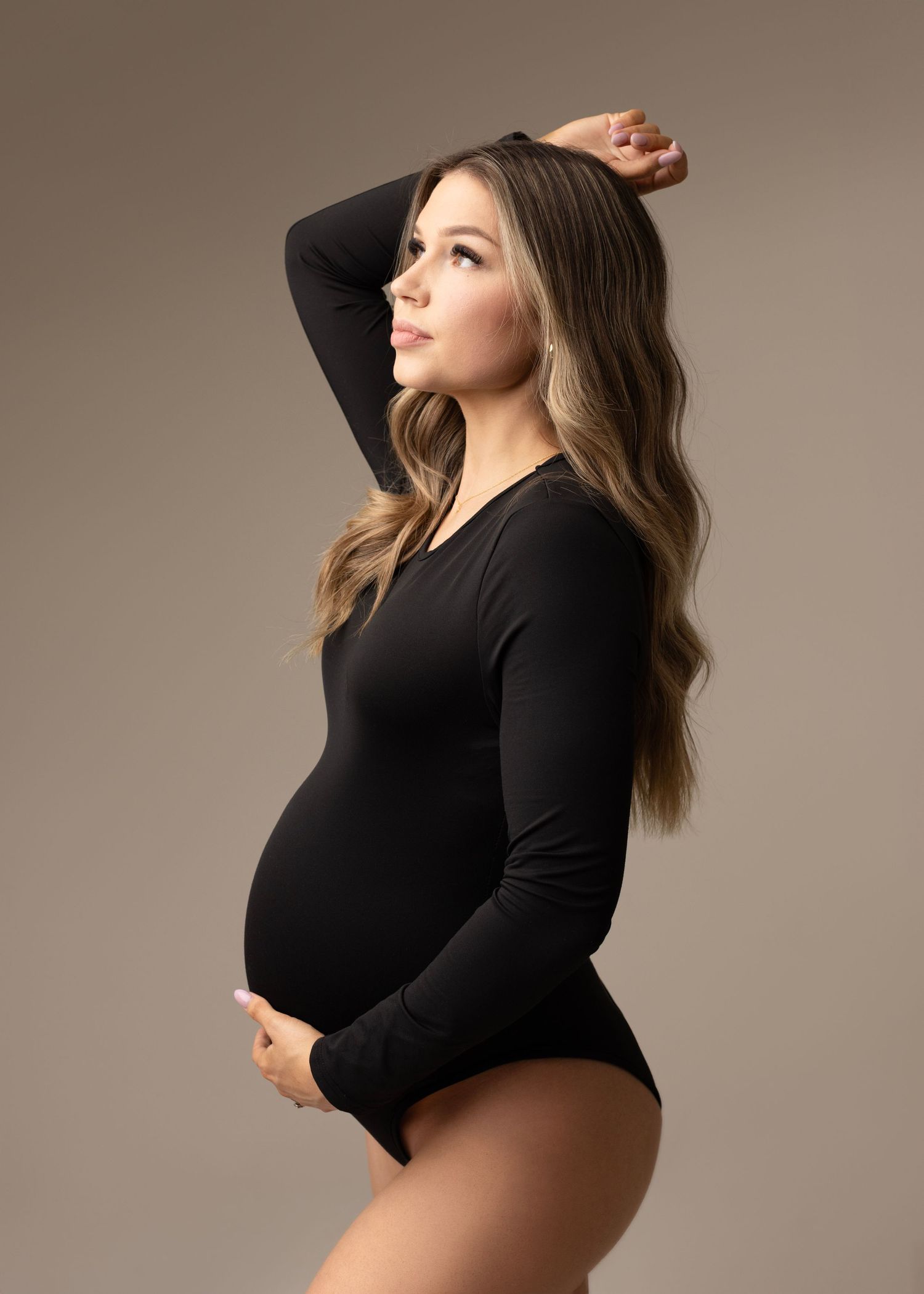 Lindsay a gorgeous mom to be so beautiful and radiant during her maternity photos with Elizabeth Lang Photography. In a black modern dress.