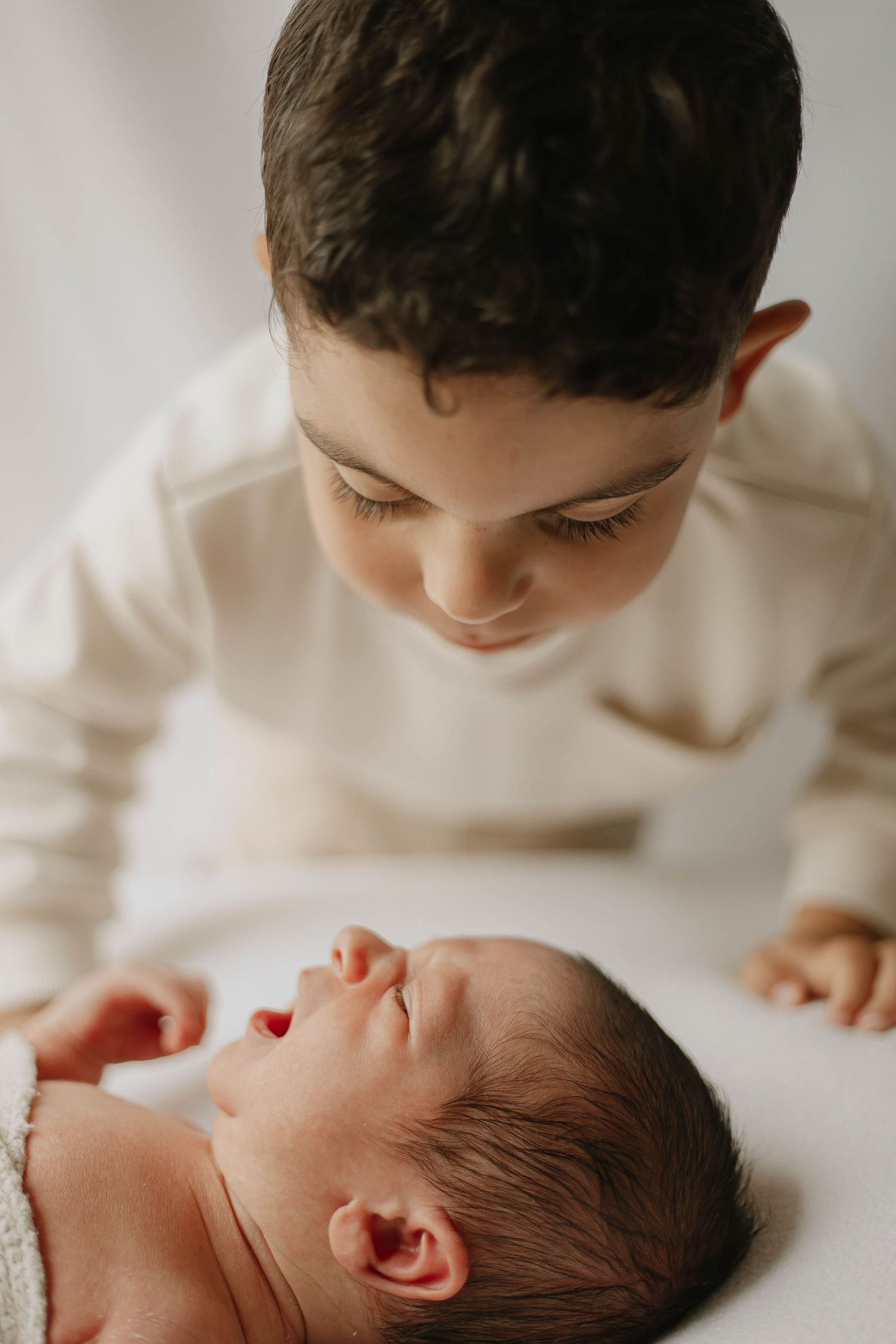 older brother and newborn during newborn photoshoot in ashford kent