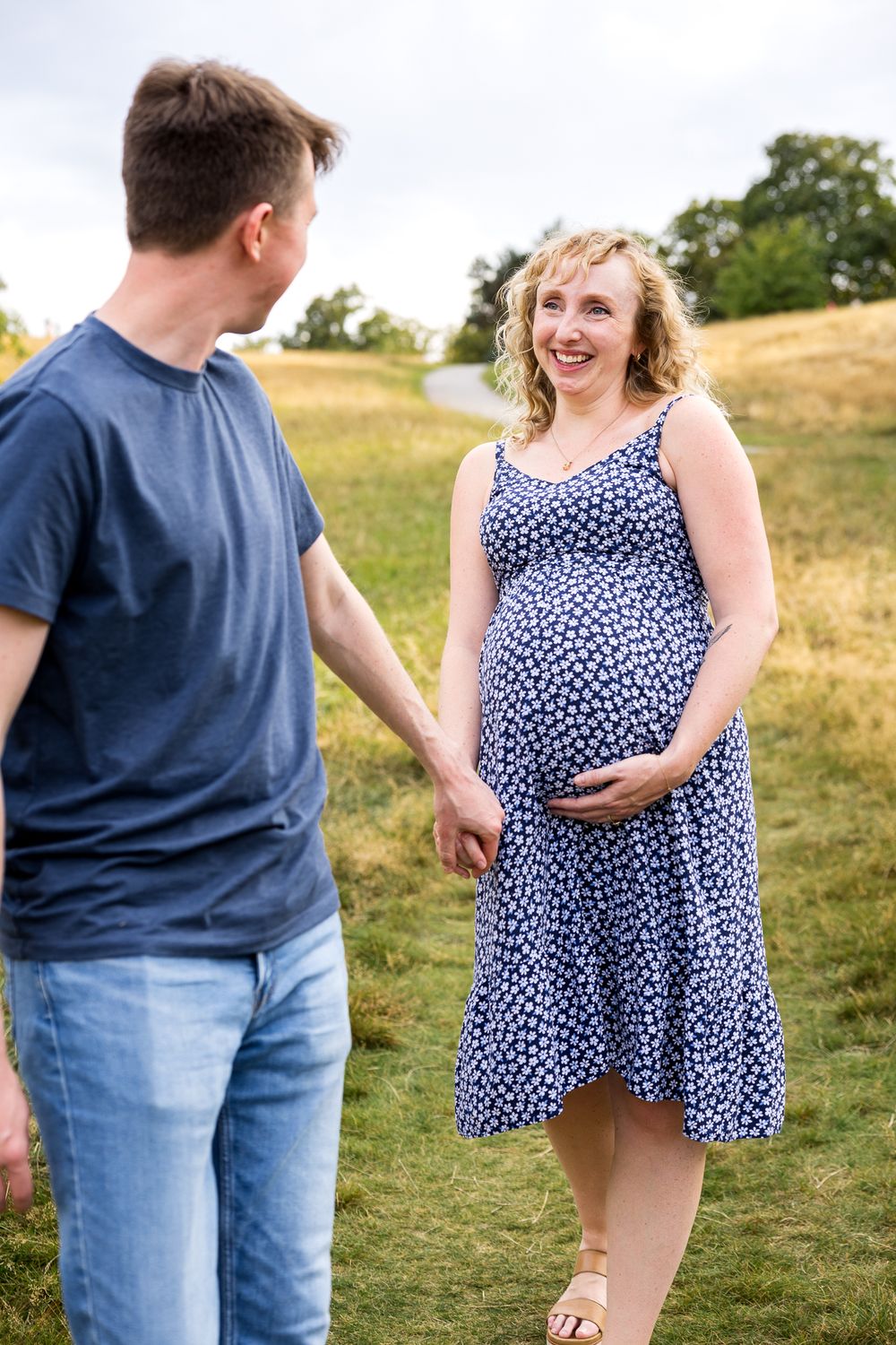 pregnant woman holding hand with her husband