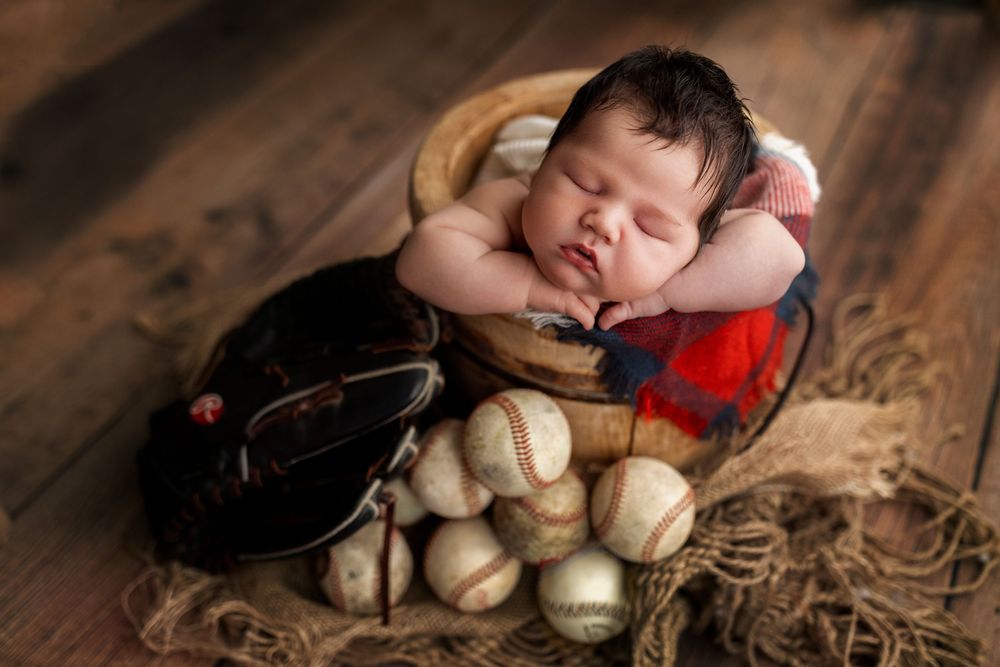 A series of artistic photos showing baseballs and gloves arranged on rustic wooden surfaces with dramatic lighting.