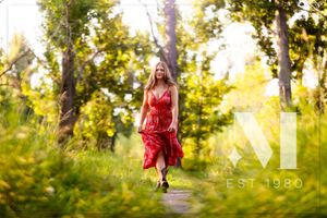 Outdoor photo session in golden evening light among trees and natural scenery.