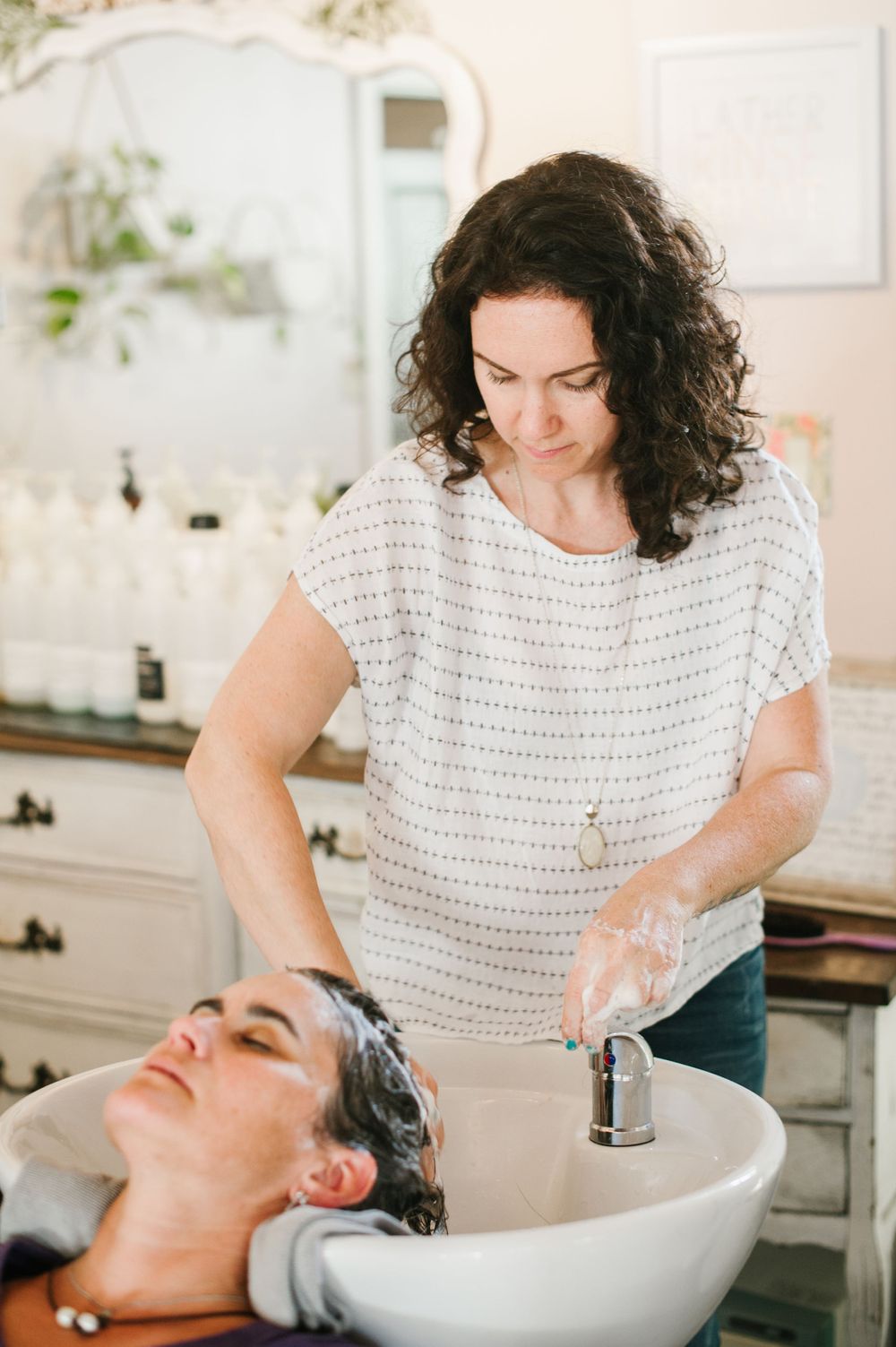 branding and lifestyle photography showing stylist washing hair