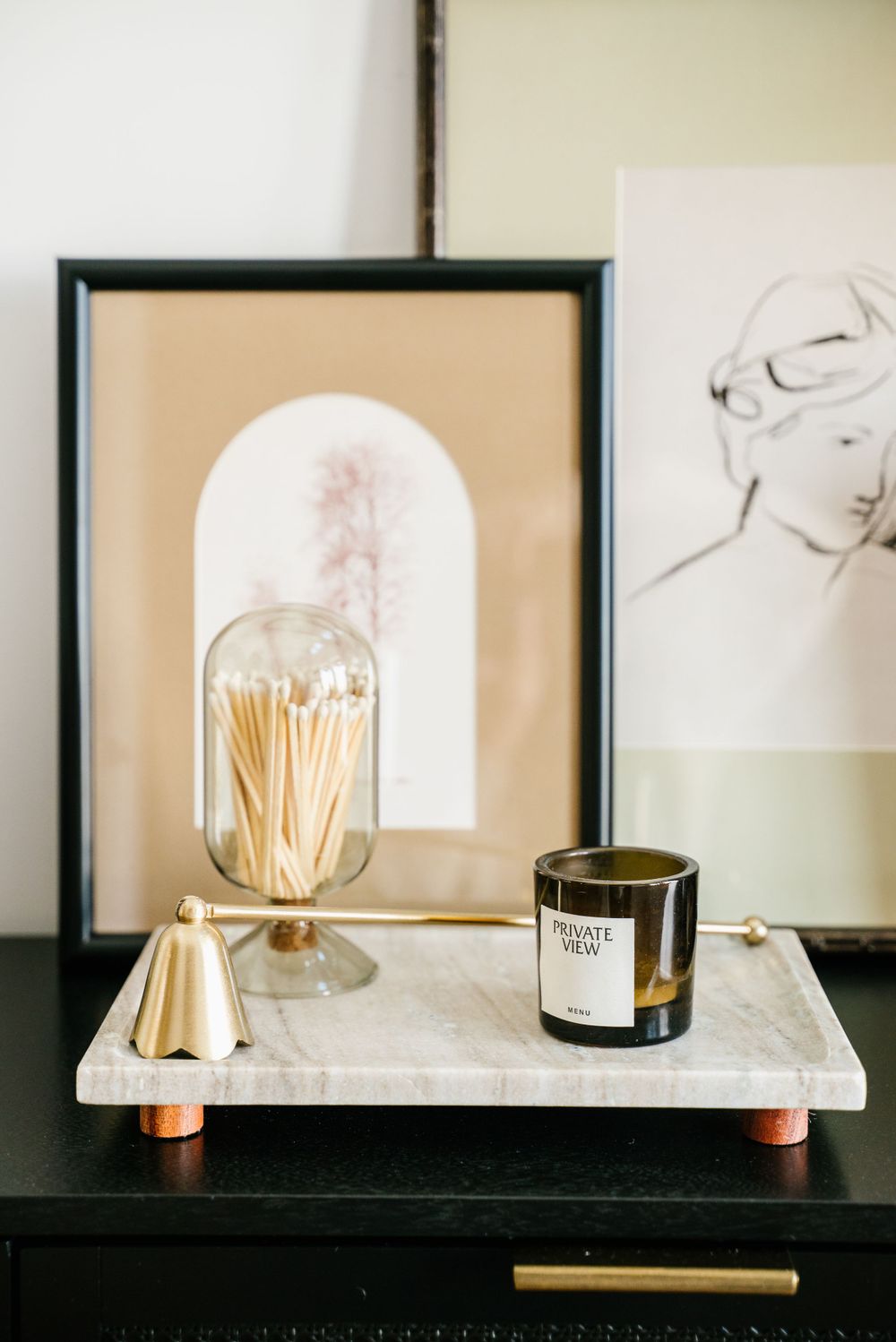 branding vignette of framed prints, candles and matches