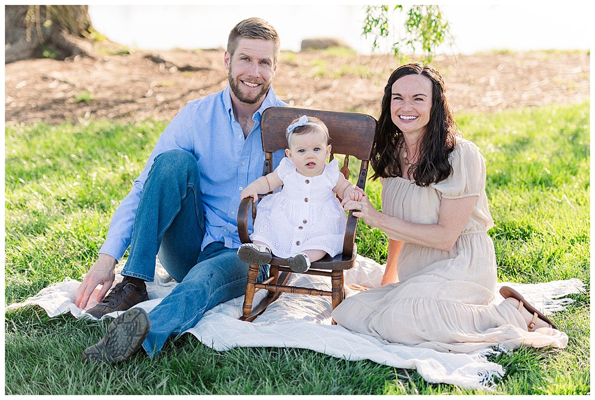 Young family sitting portrait by lake at Coxhall Gardens Carmel Indiana