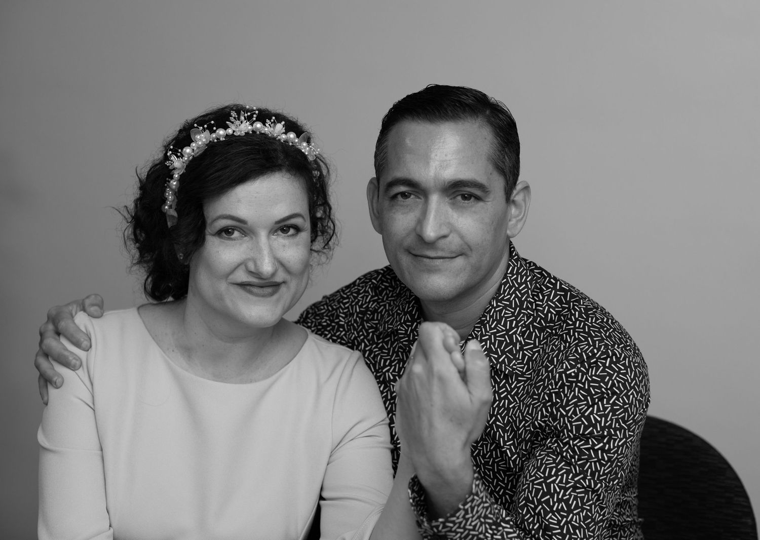 Vintage-style portrait of couple with bride wearing classic headpiece.