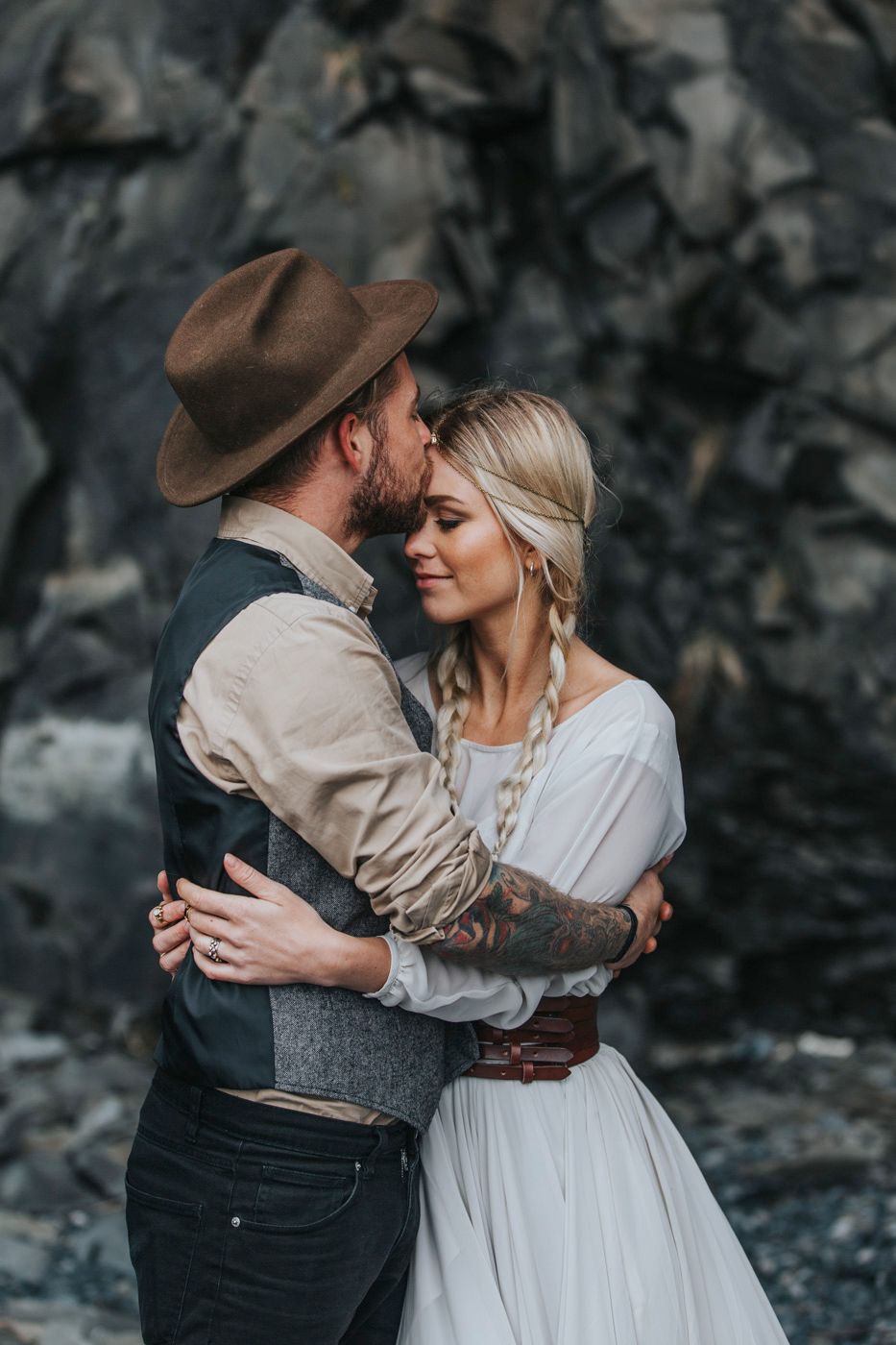 Intimate wedding portrait showing couple in vintage-inspired attire sharing close embrace.