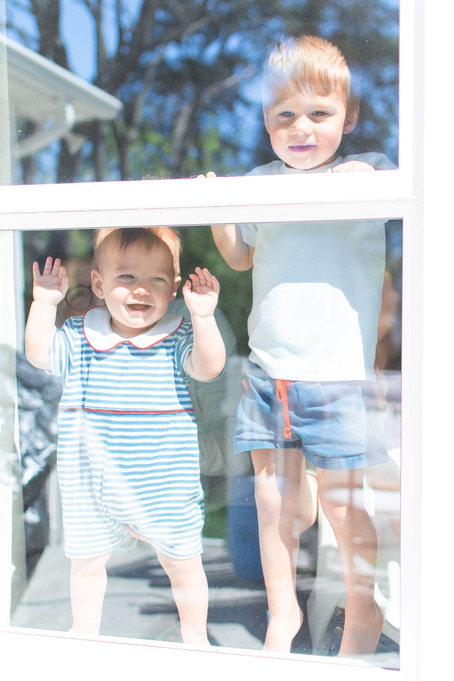 Looking in from the outside, a family snuggles in their Ardmore Historic District bedroom.