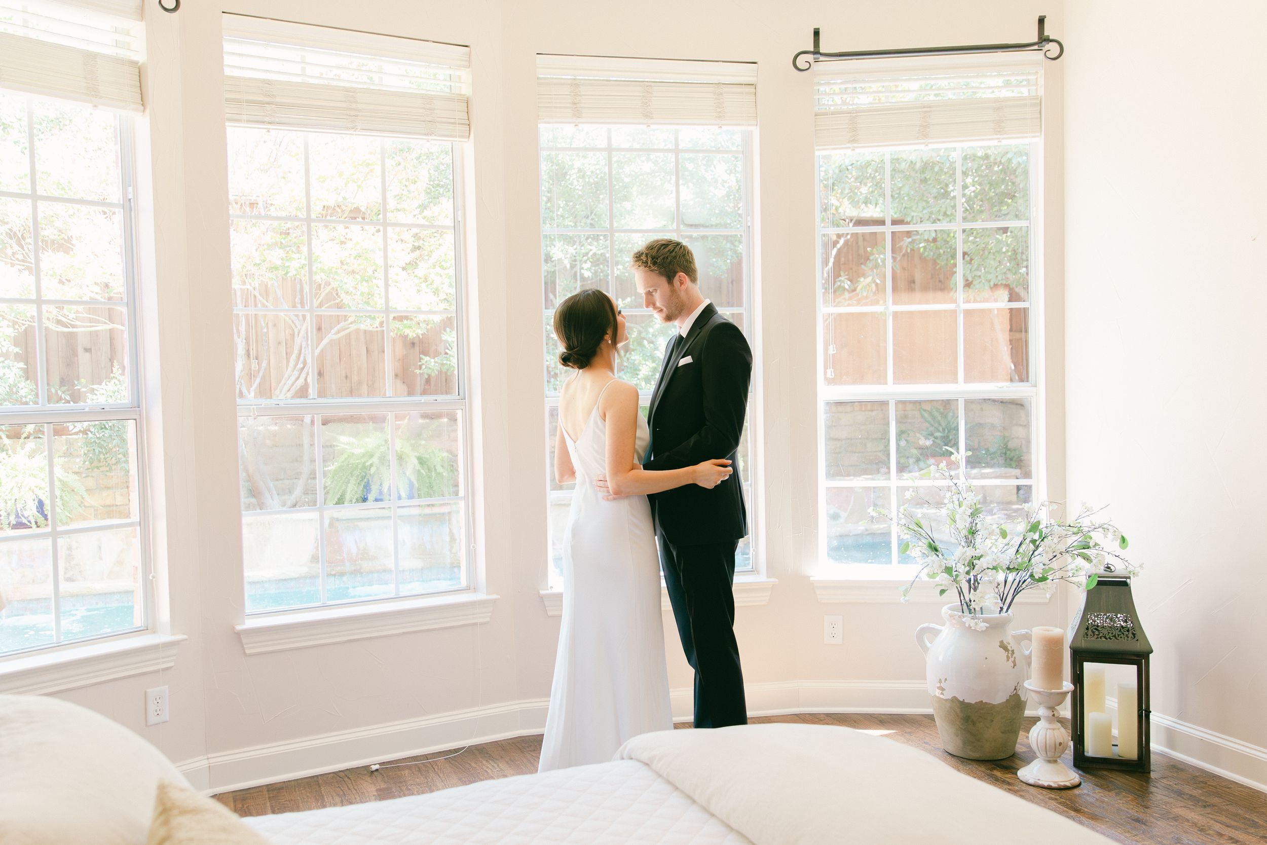 Sunlit wedding venue featuring curved windows and romantic minimalist decor.