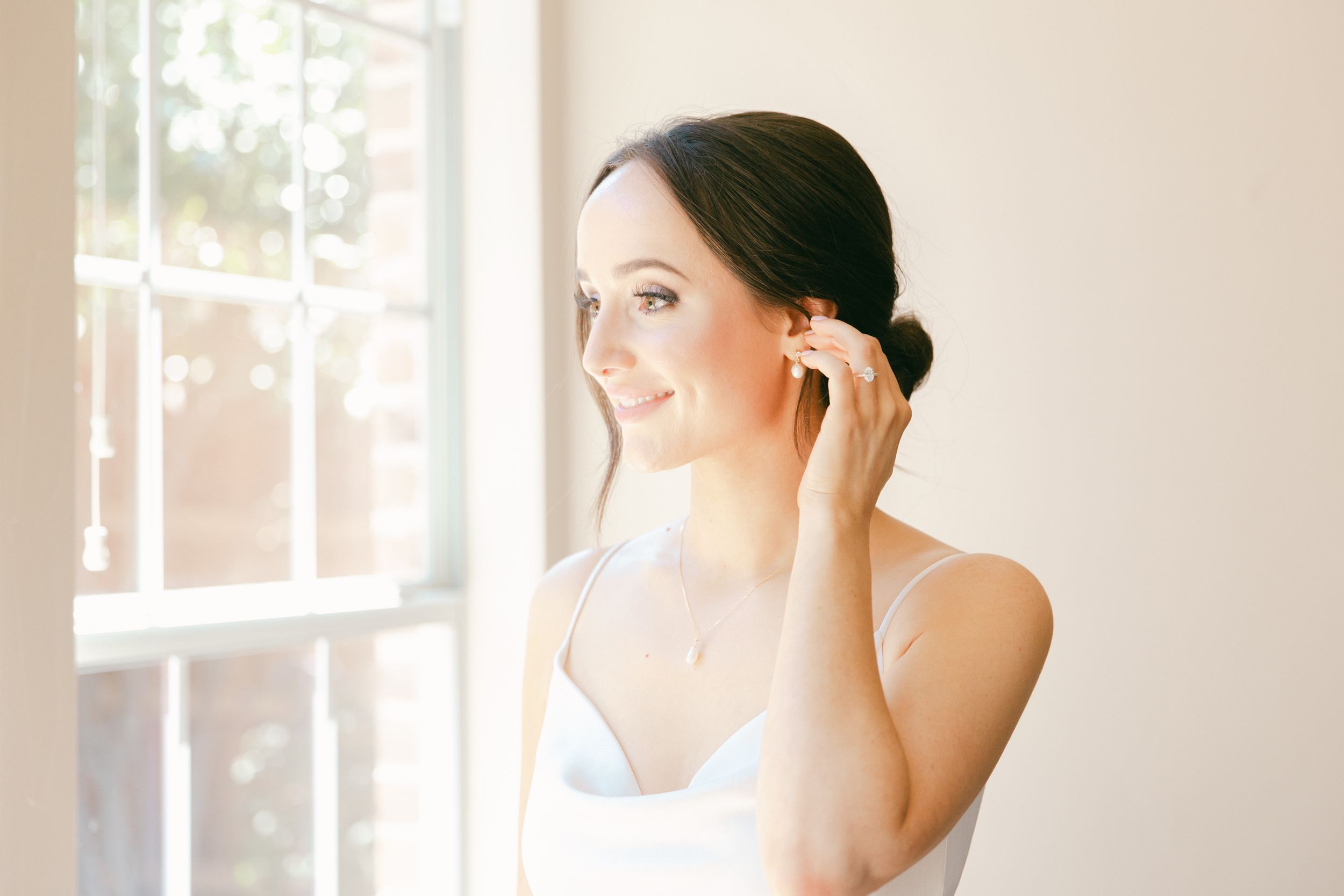 Light-filled interior wedding venue with soft white walls and elegant decor.