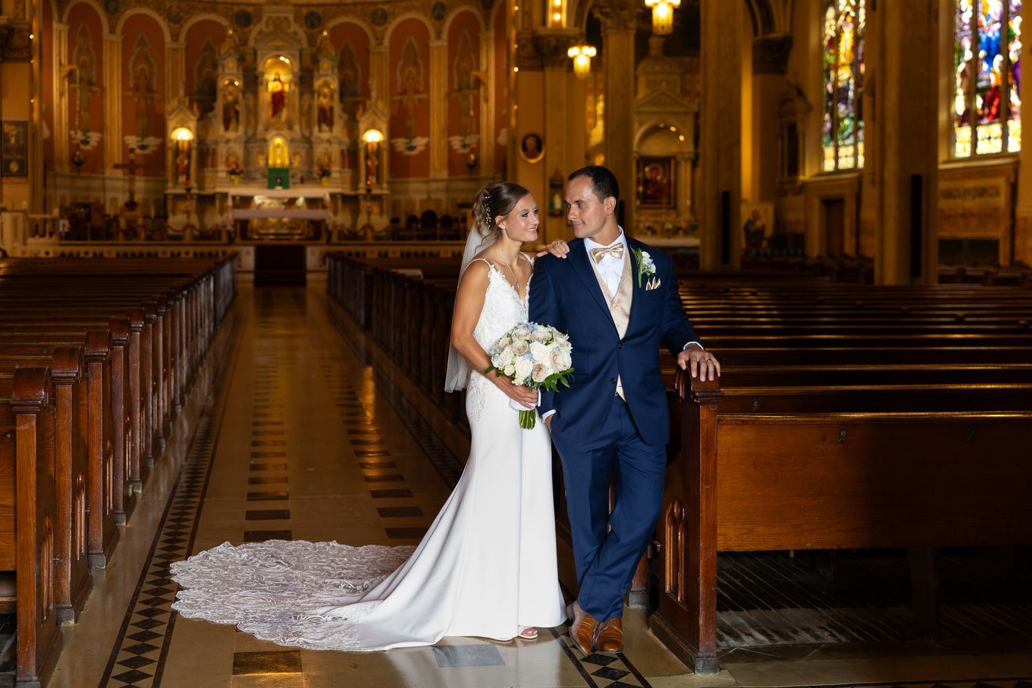 Couples share romantic slow dance moments on dimly lit ballroom floor.
