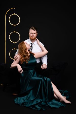 Romantic couple photography sequence showing intimate poses against dark backdrop with emerald green dress.