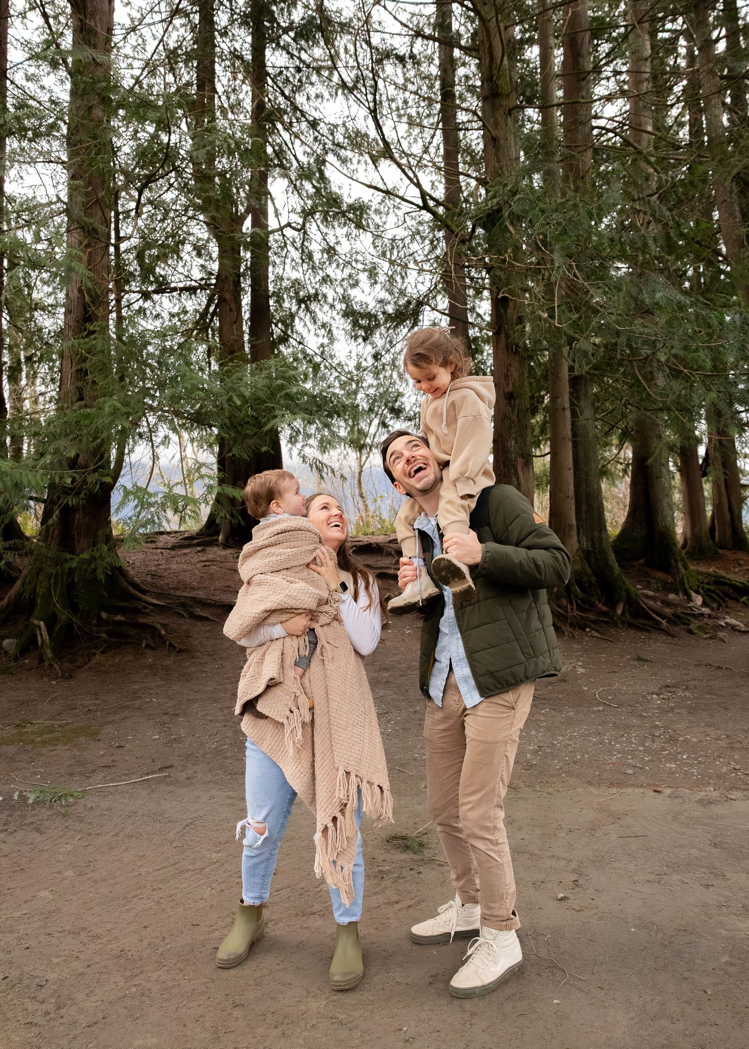 A playful sequence of four photos showing people dancing and twirling together in a forest setting.
