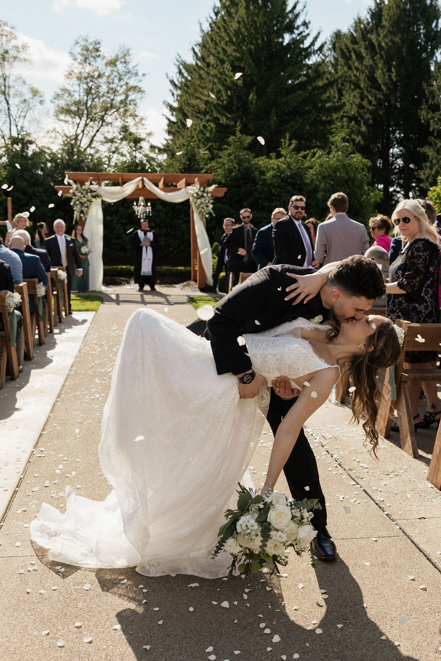 An intimate wedding moment captured during golden hour with fall foliage in the background.