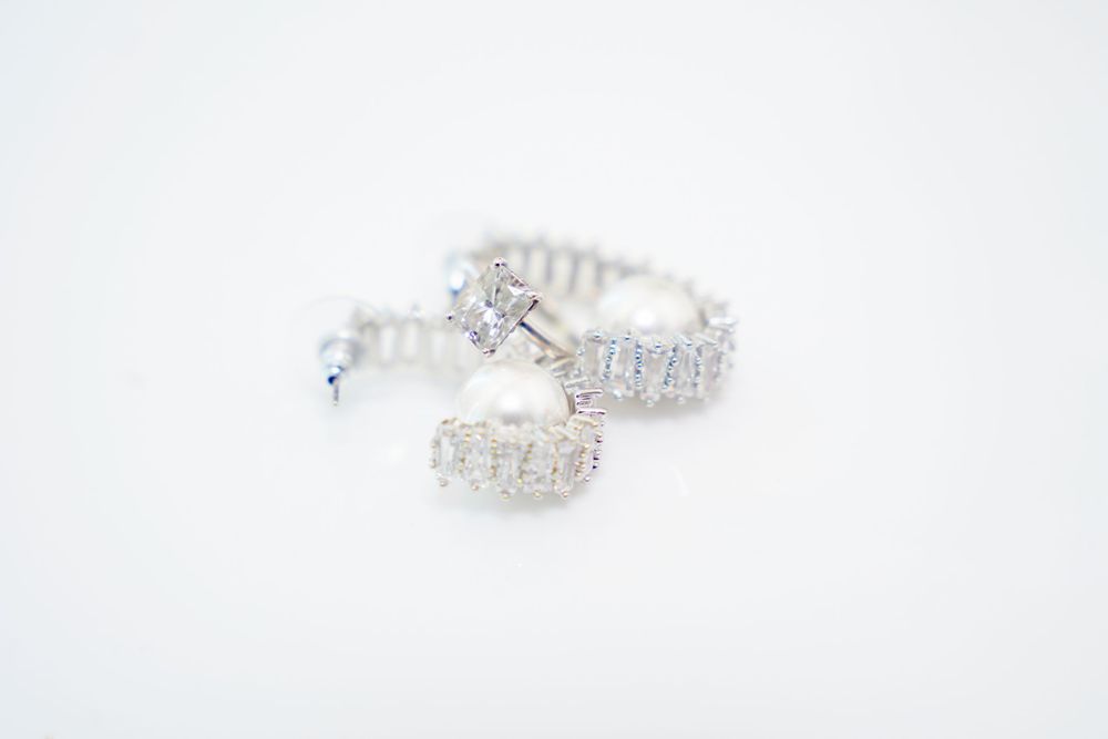 Elegant crystal and silver plated drop earrings sparkle with brilliant clarity against a white background.