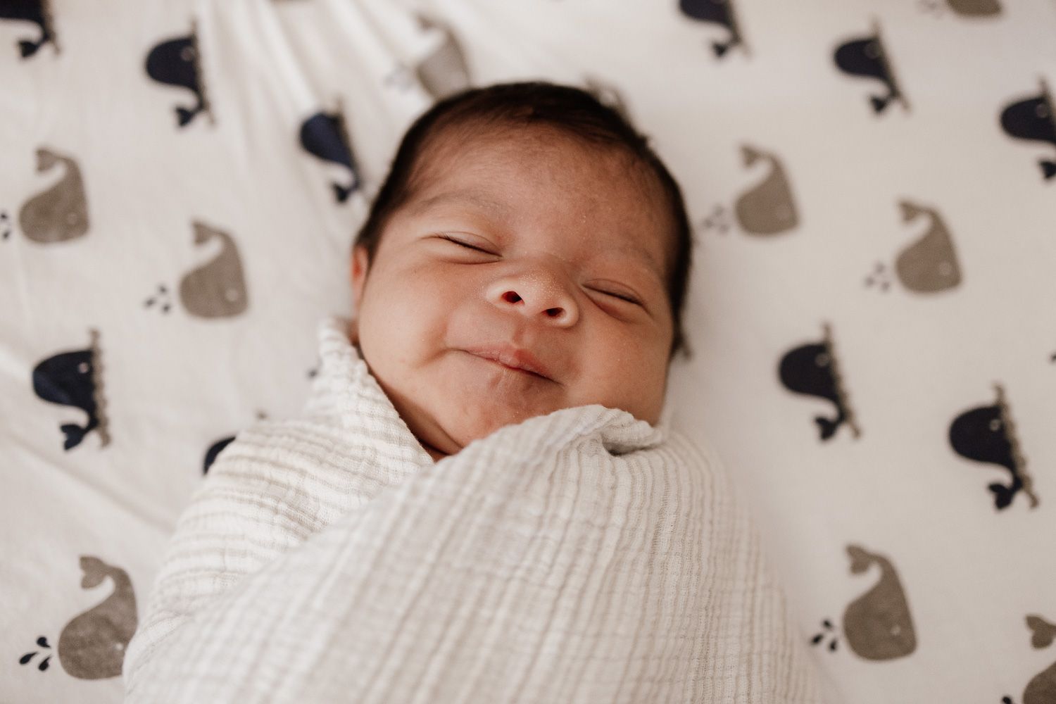 Close-up of a smiling sleeping baby