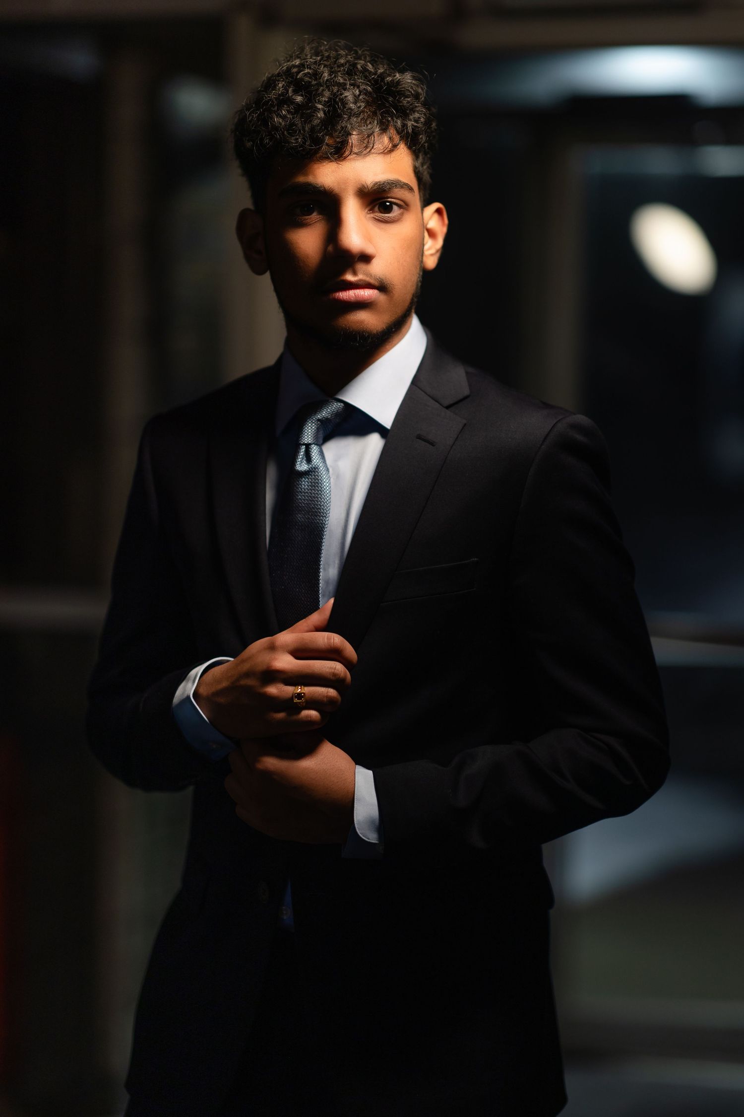 Stylish portrait series showing man in black suit with dramatic lighting and composition.