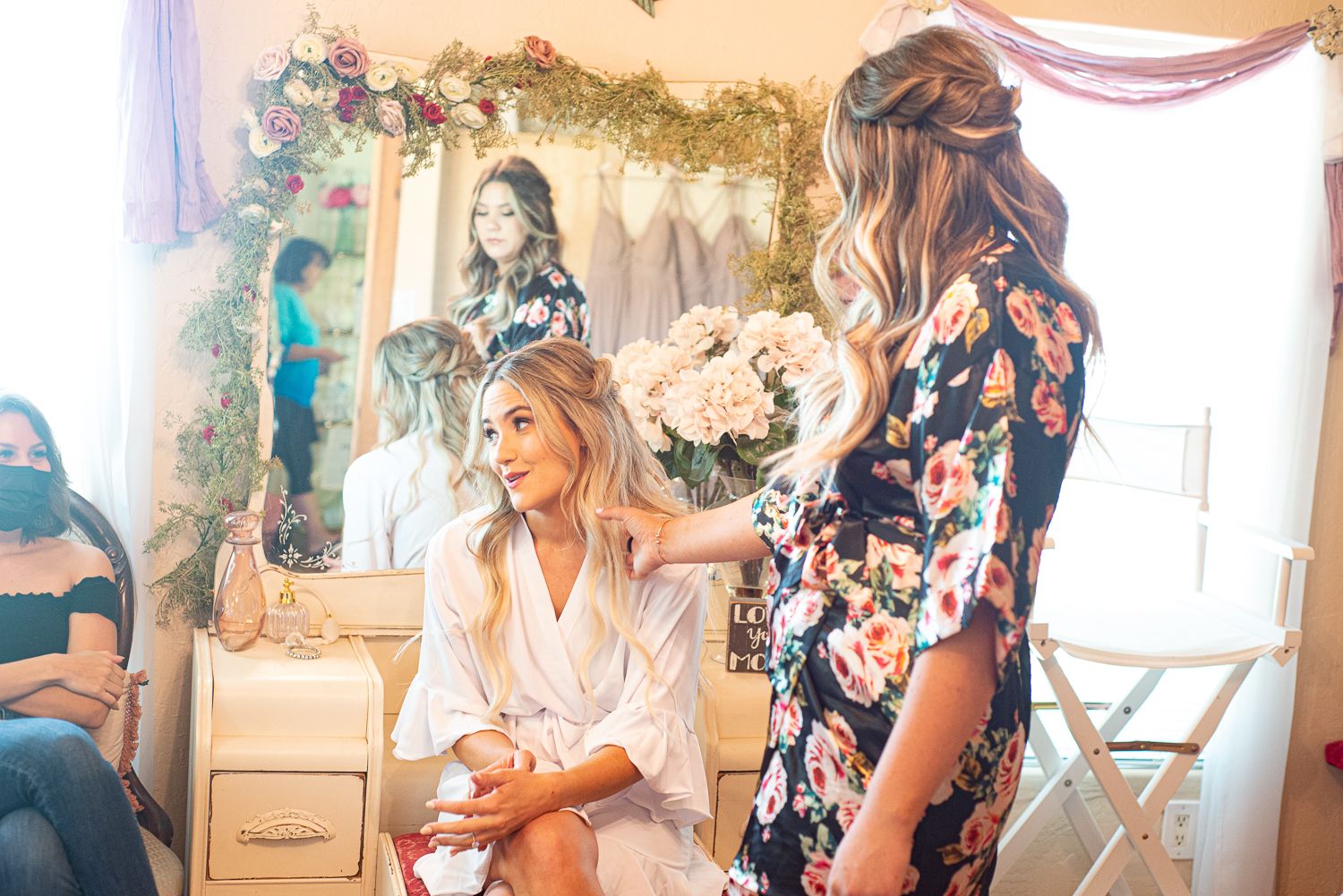 Getting ready scene in a bridal suite with floral robes and elegant decor.