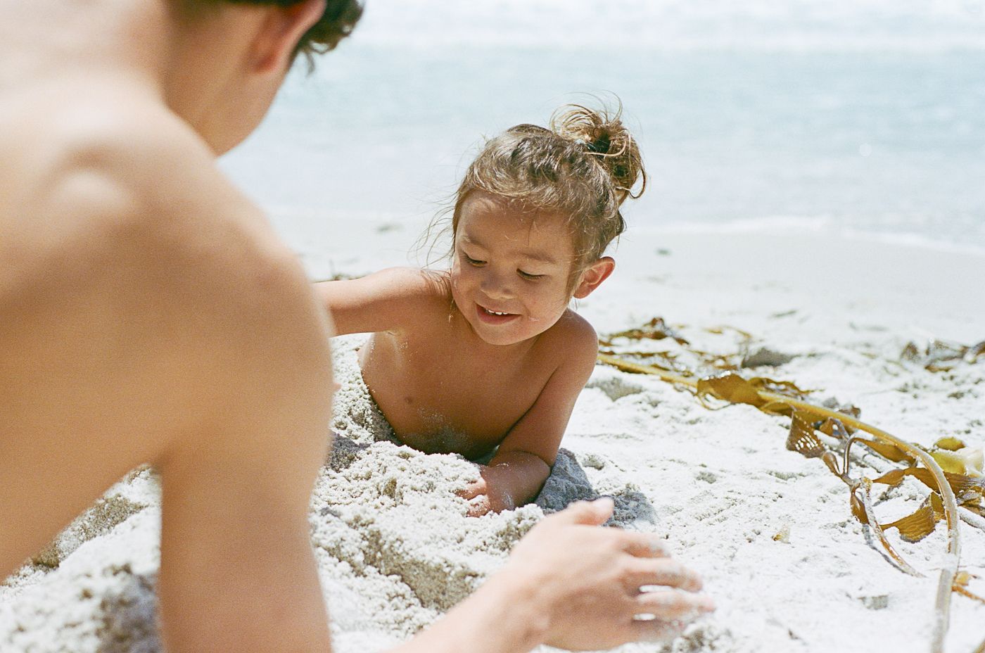 Close up shot of beachgoers enjoying themselves in the sand.