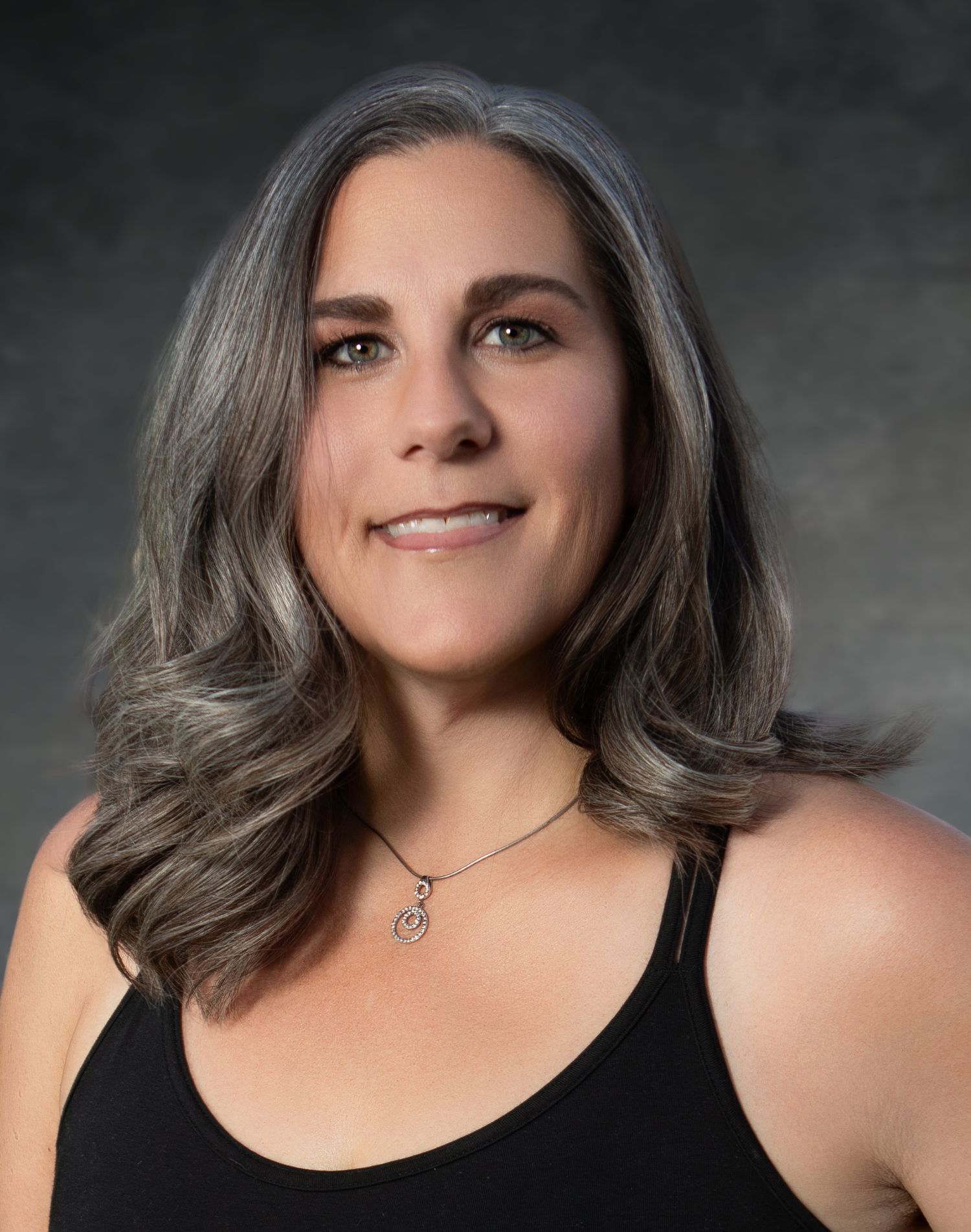 Professional headshot series showing long gray hair and minimal jewelry against dark background.