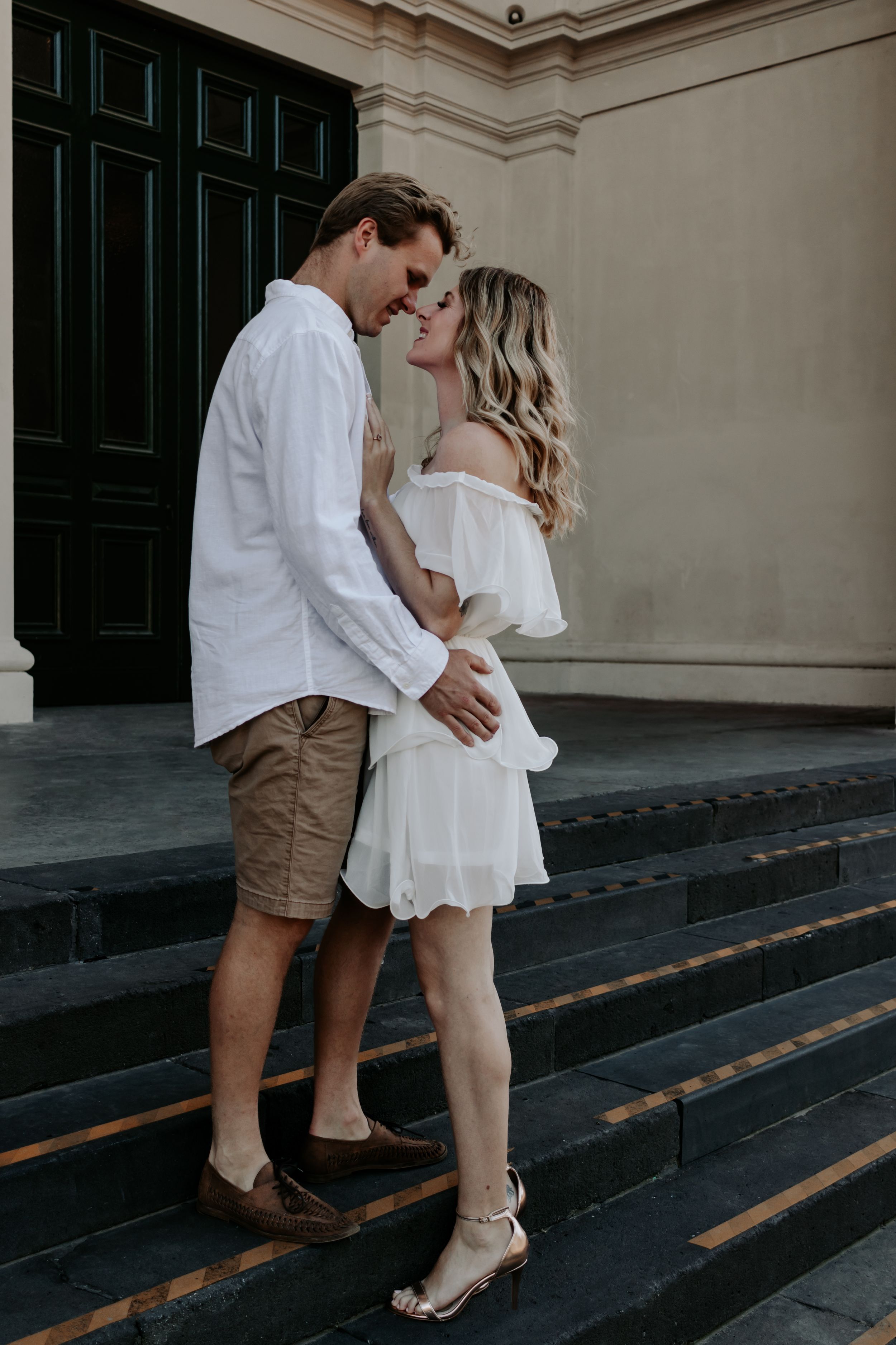 An engaged couple looking at each other.