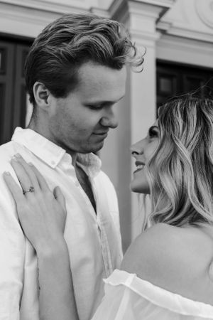 An engaged couple looking at each other.