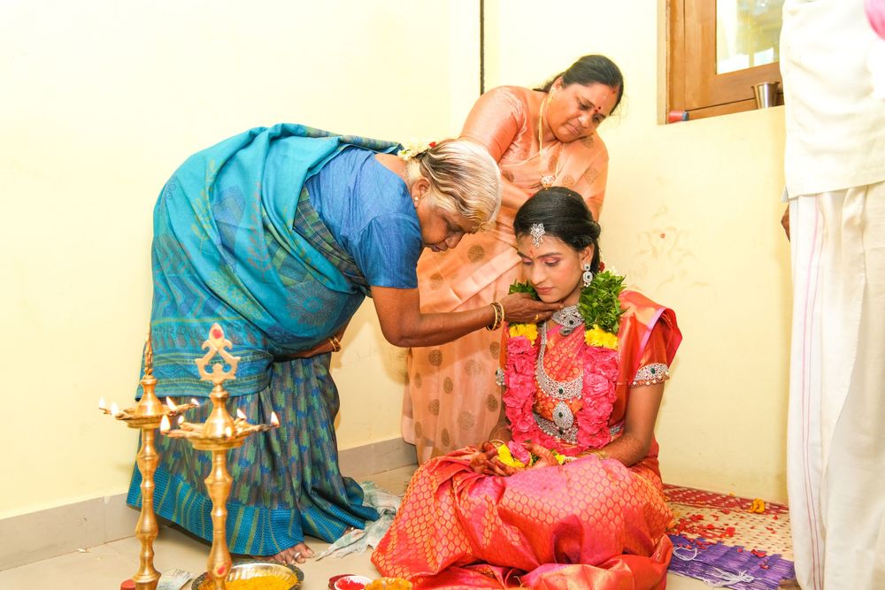 Traditional Indian ceremony with women in colorful saris performing rituals and blessings.