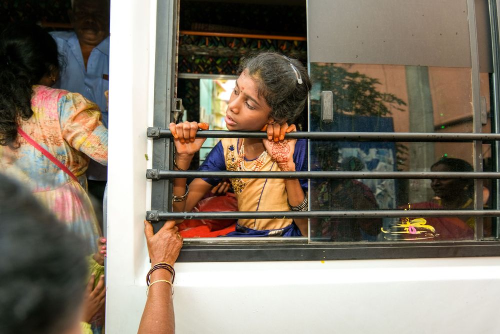 Traditional South Indian ritual being performed through a window.