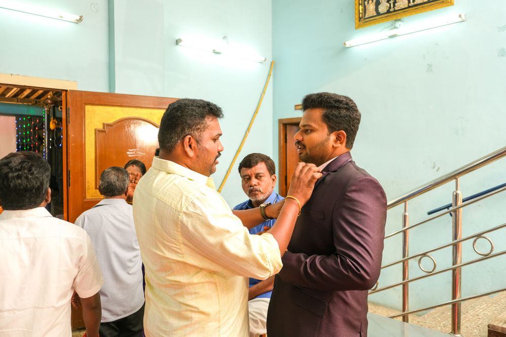 Traditional greeting and conversation in indoor setting with decorative railings.